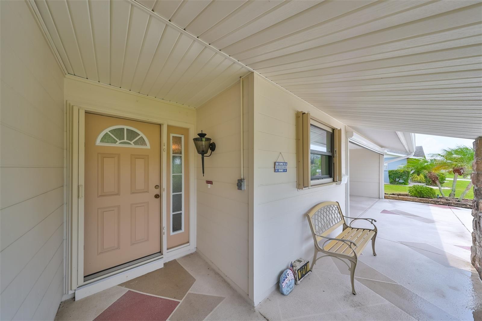 The front door cover protects you from the elements, has a 'hidden' screen door and a front porch to watch the world go.