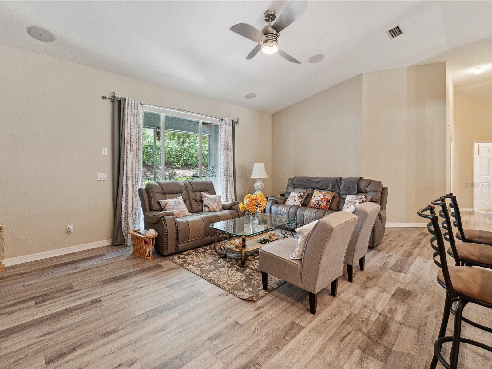 The great room was built for entertaining and can blend seamlessly with the outdoor enclosed lanai.