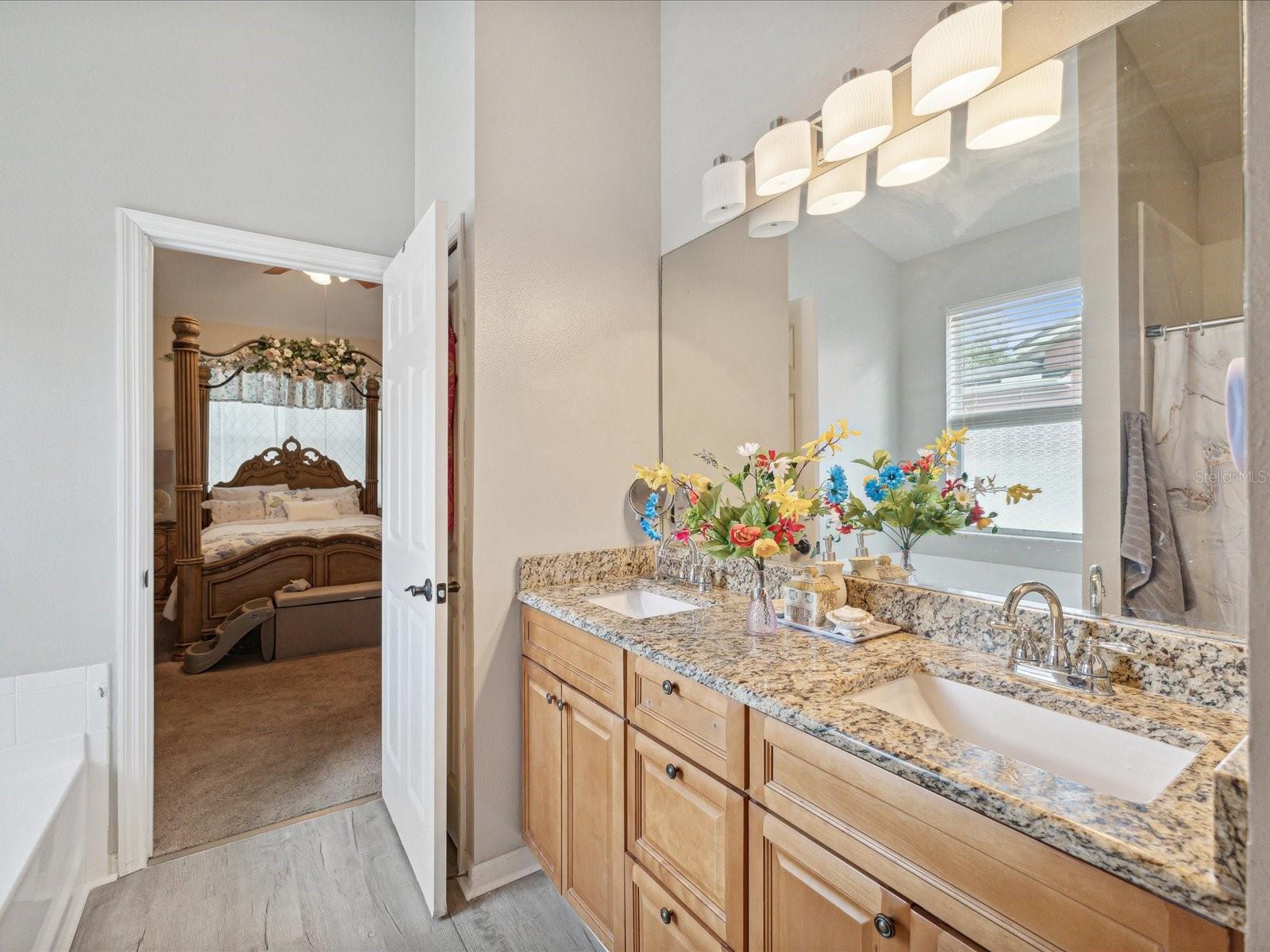 There is no need to fight for space when this bathroom comes equipped with double vanities, extra storage, and timeless granite countertops.