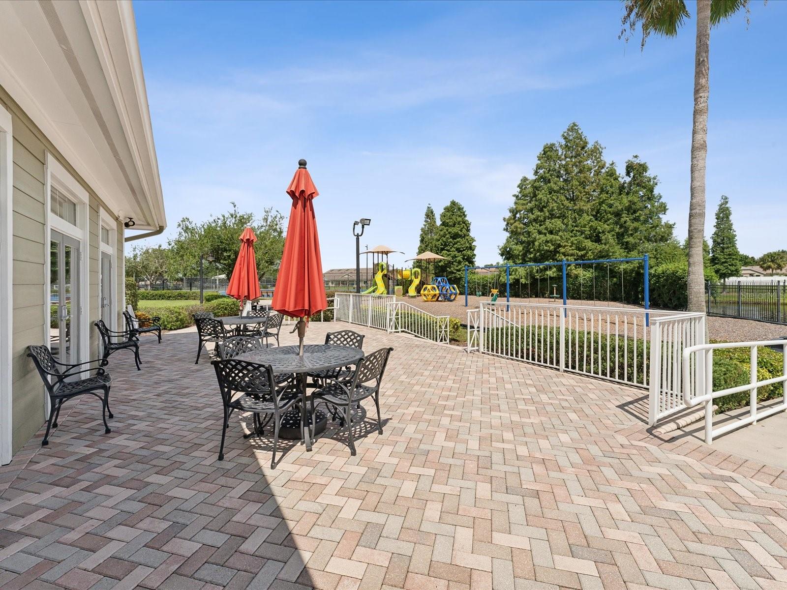 Watch the playground from the comfort of the shade with this umbrella covered table. Pavers give the clubhouse grounds an immaculate appearance.