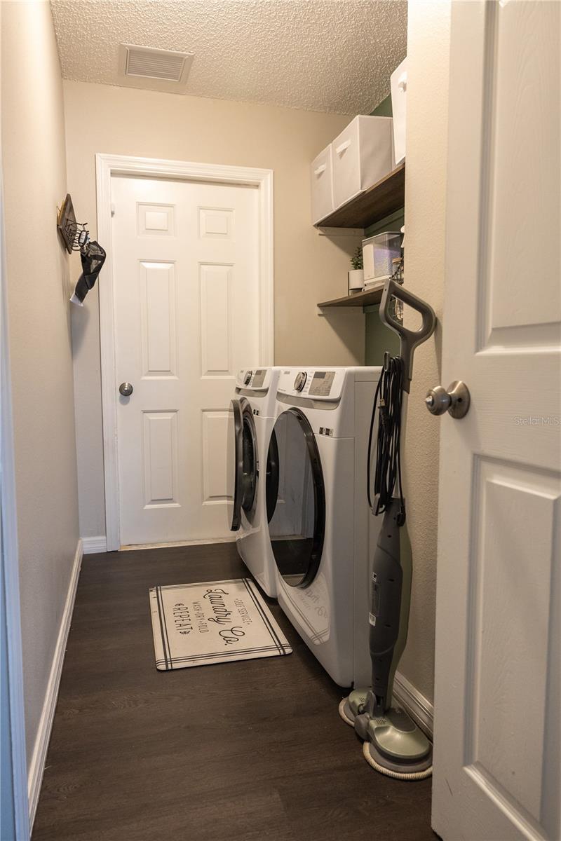 Laundry room that is inside that leads to garage