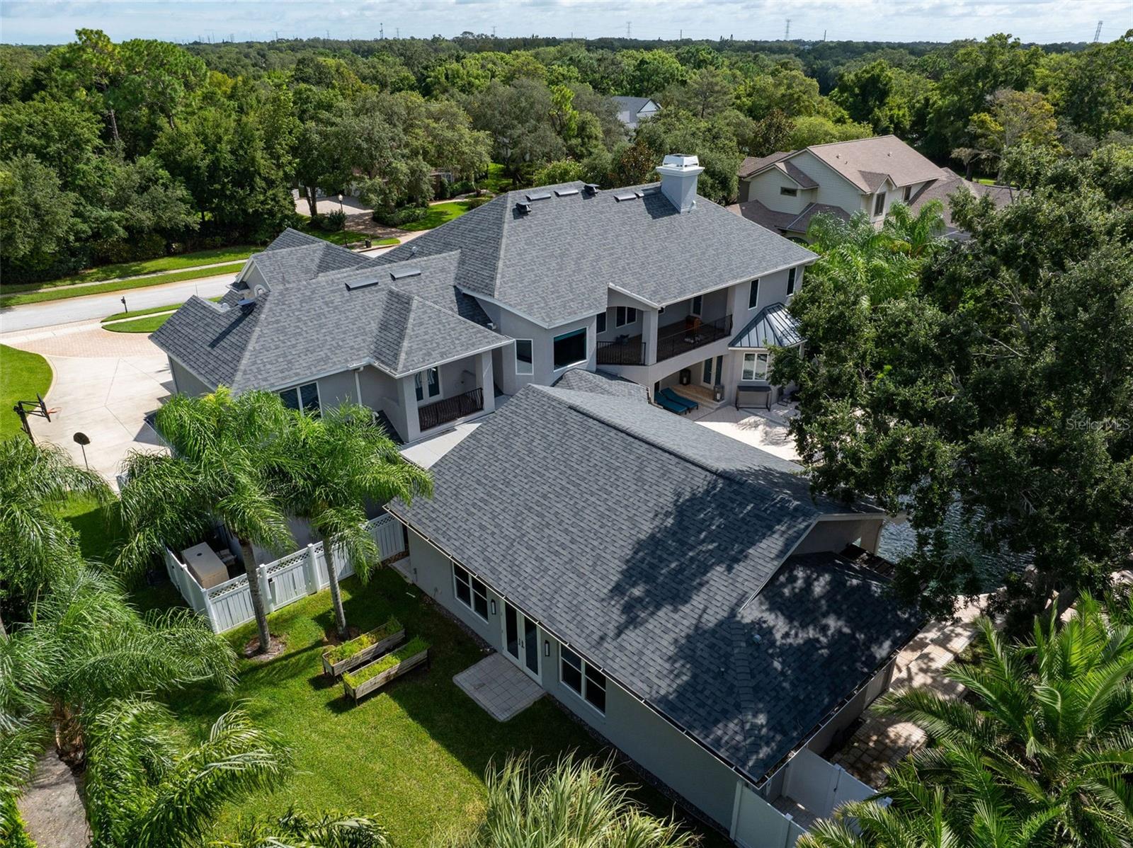 Rear view of property showing large poolside addition