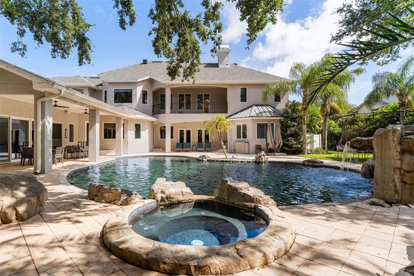 Jacuzzi located behind the pool; this shot is facing pool and home.