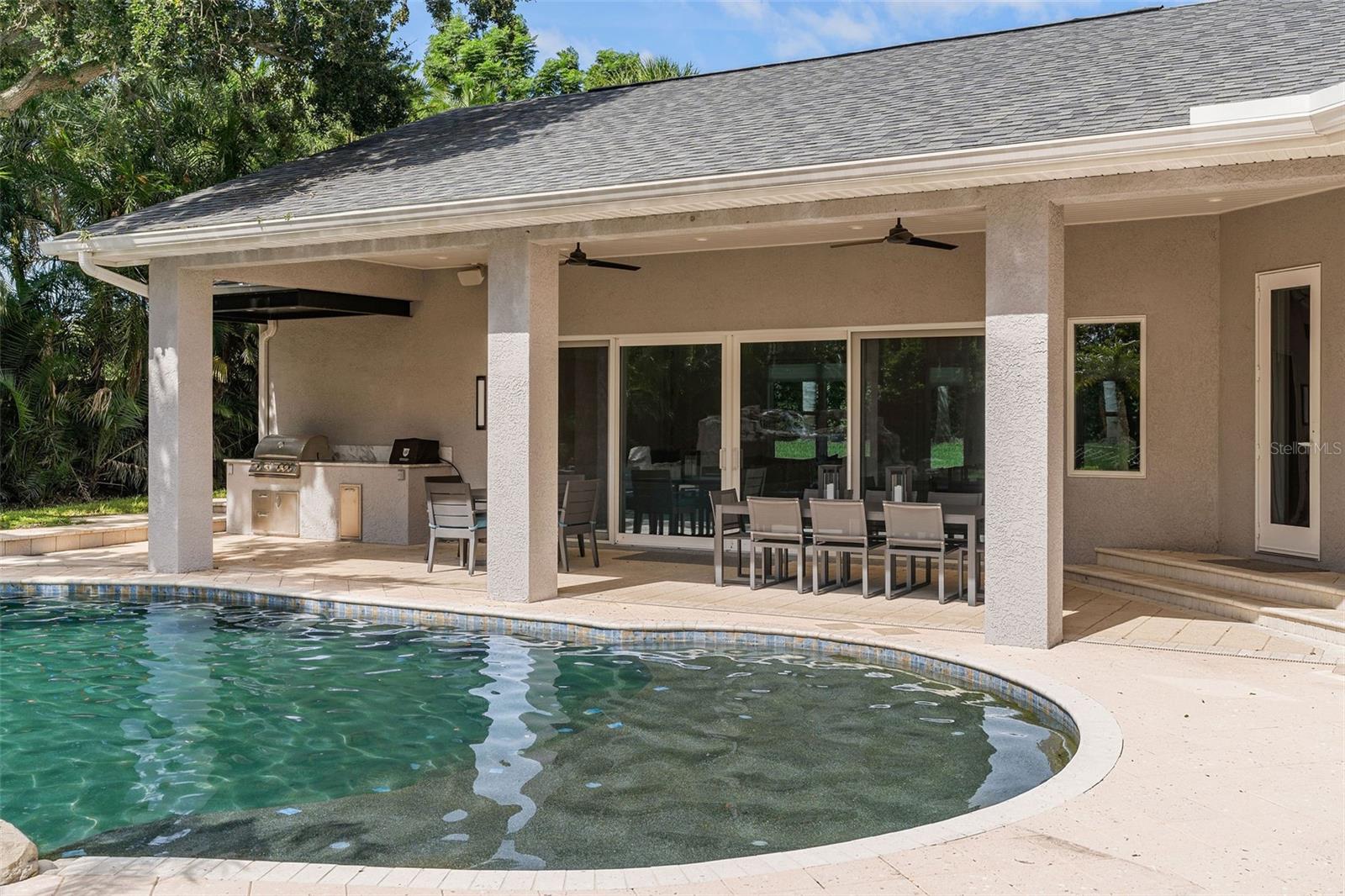 Barbecue and patio and poolside activity room off the pool