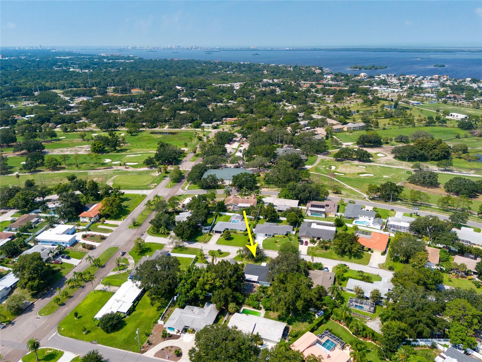 This aerial view of the home is looking a bit Southwest.     You can see portions of the Dunedin Golf Club mid photo and at the top is the Intracoastal Waterway and Clearwater Beach.