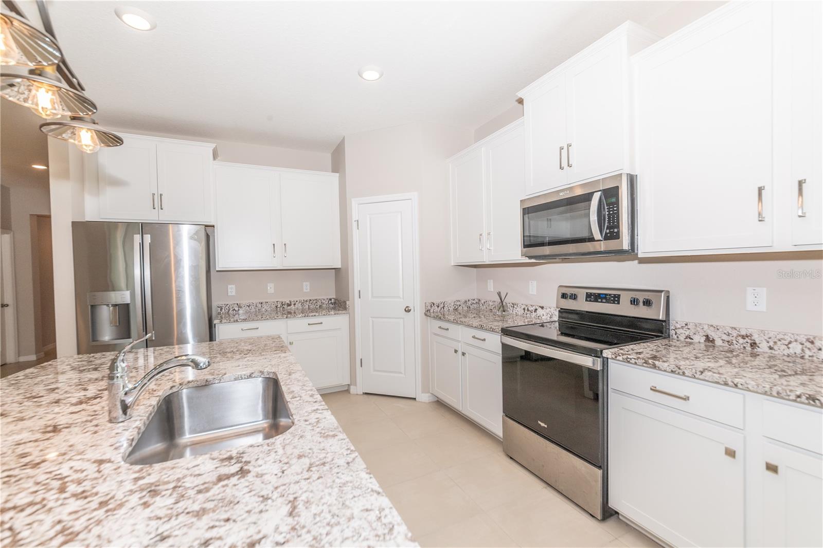 Kitchen with stainless steel appliances and sink