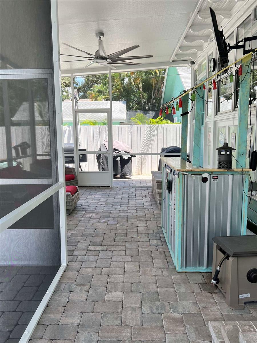 NO-SEE-UMS Screen enclosed patio! HUGE fan! TV + Bar area. Entrance to kitchen and bathroom.