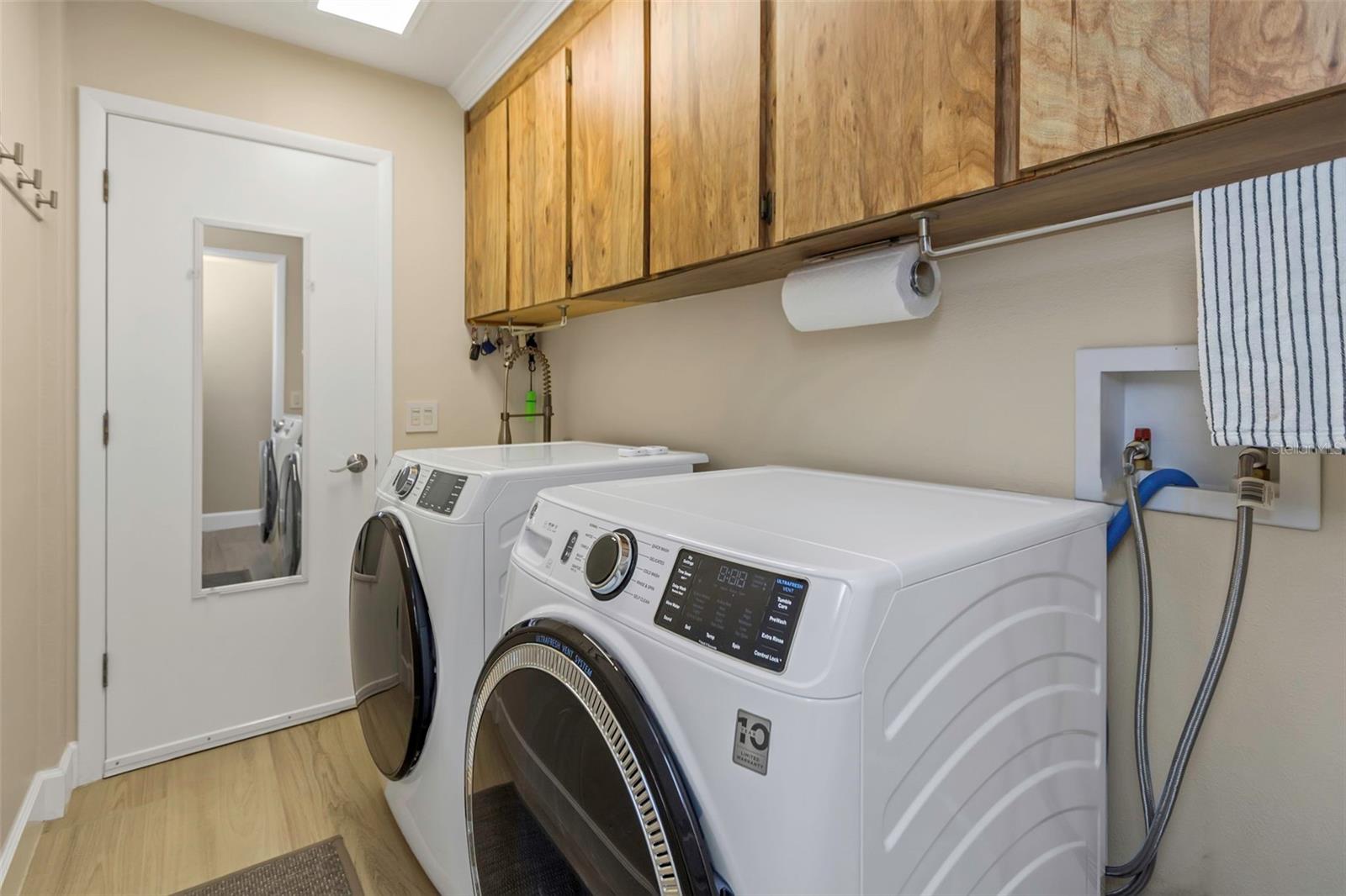 Interior laundry room with washer and dryer and garage access.