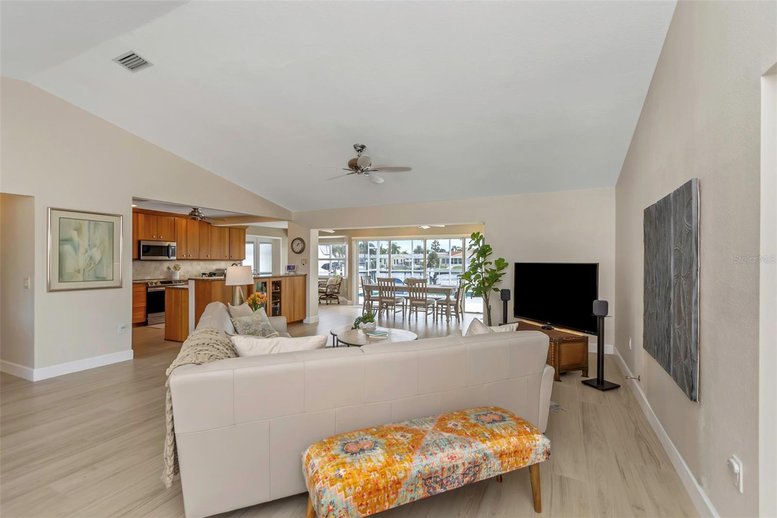 Step through the front entryway and the open floor plan provides an unobstructed view to the pool and wide saltwater canal.