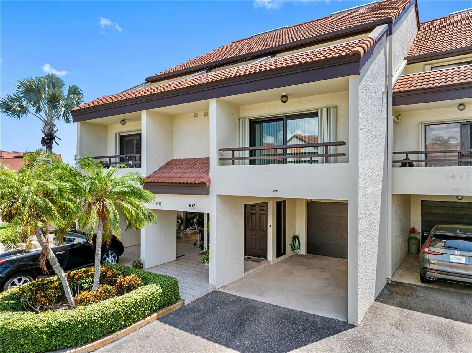 Front of the home with carport and 2 balconies