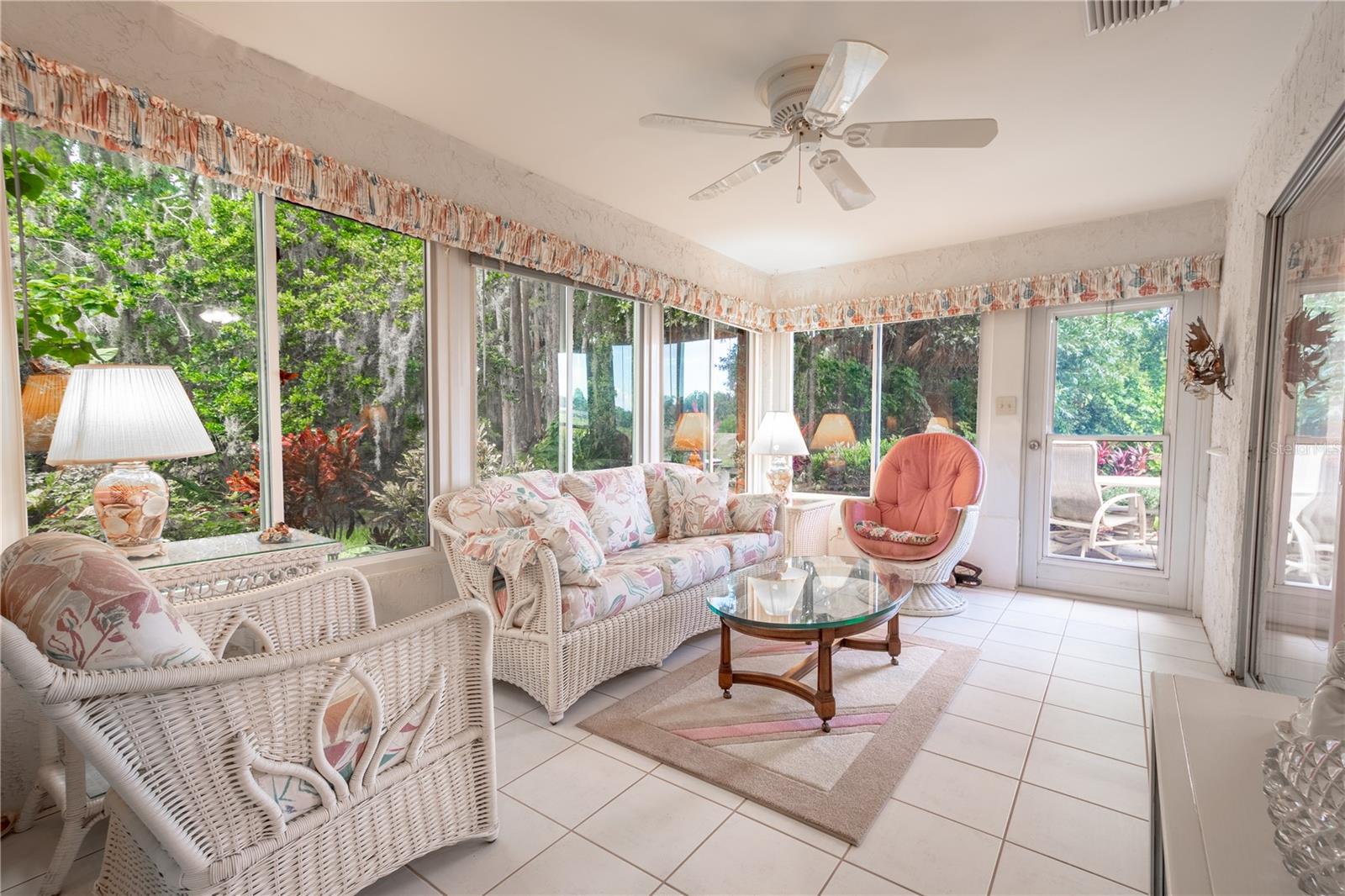 The air conditioned Florida room features wall-to-wall windows (no neighbors on the side or back)  bringing the outside in.