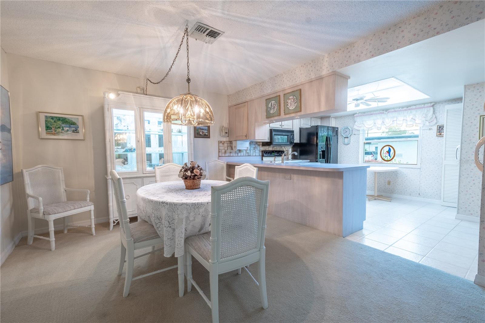 The centerpiece of the dining room is the chandelier, the homeowner brought back from Austria.