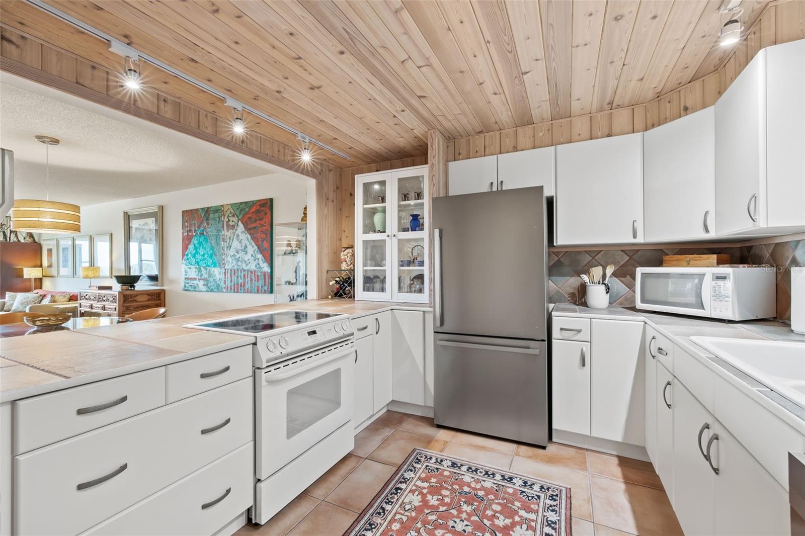 Coastal, chic kitchen with great countertop and cabinet space.