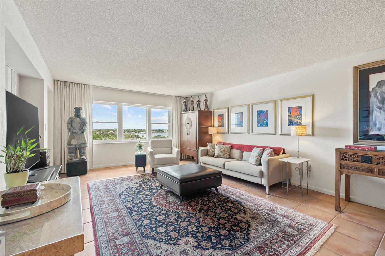 Oversized living room perfect for entertaining. Door to the balcony is to the left of the statue.