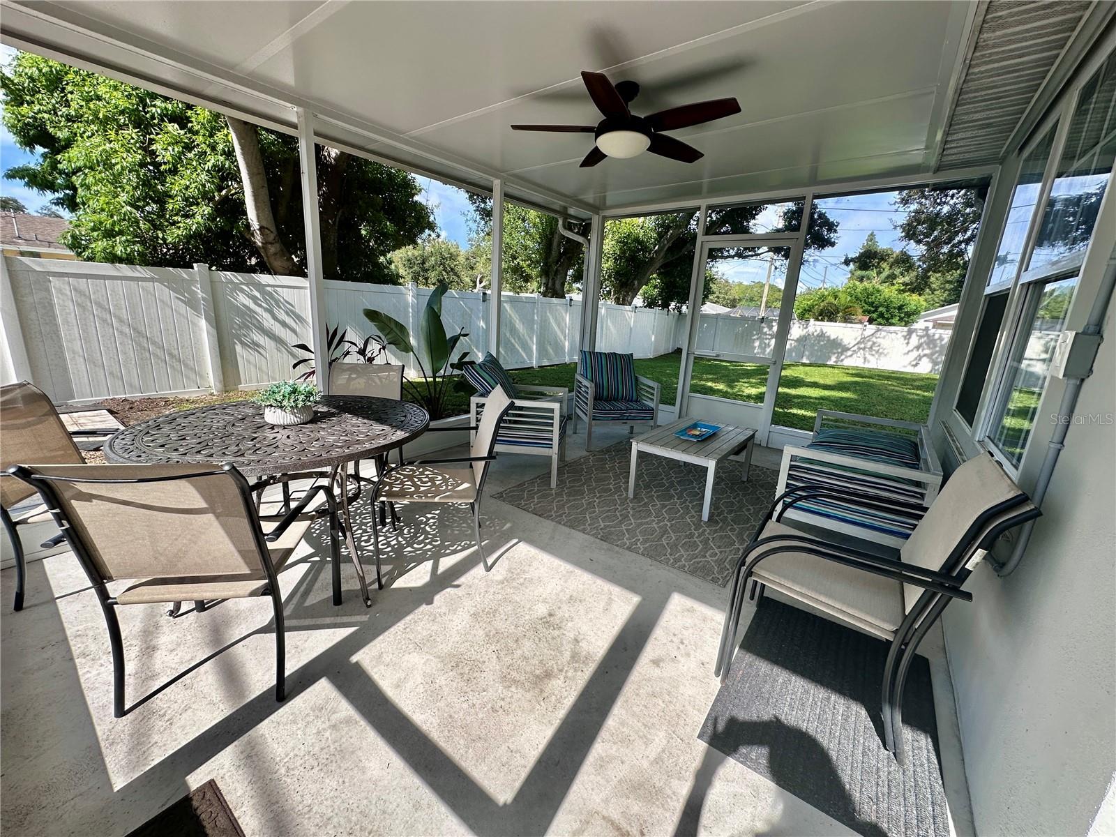 Screened patio offers plenty of sitting area