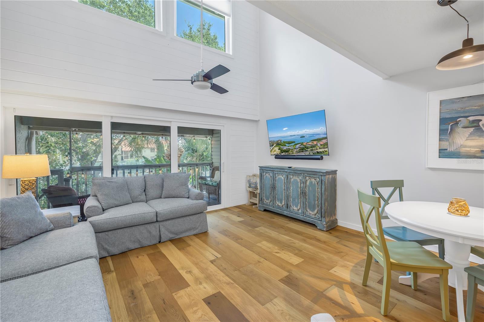 Living area has vaulted ceiling and impact sliding doors