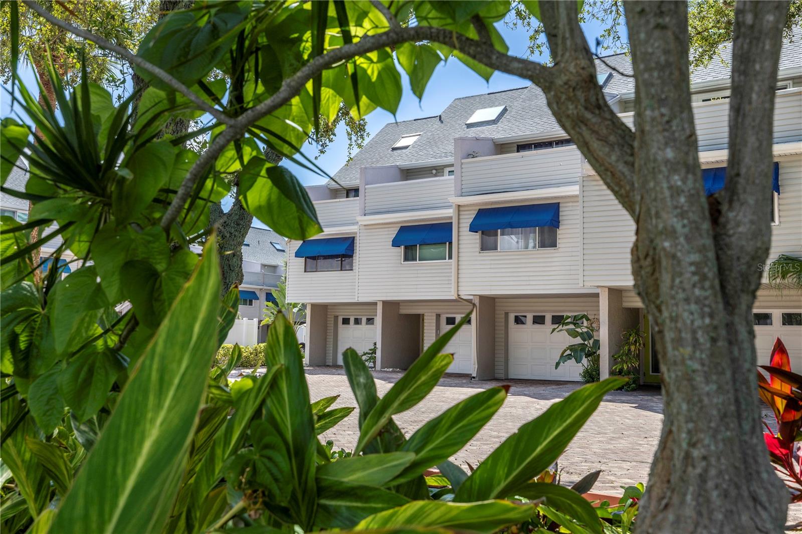 Lush landscaping and brick paver parking lot