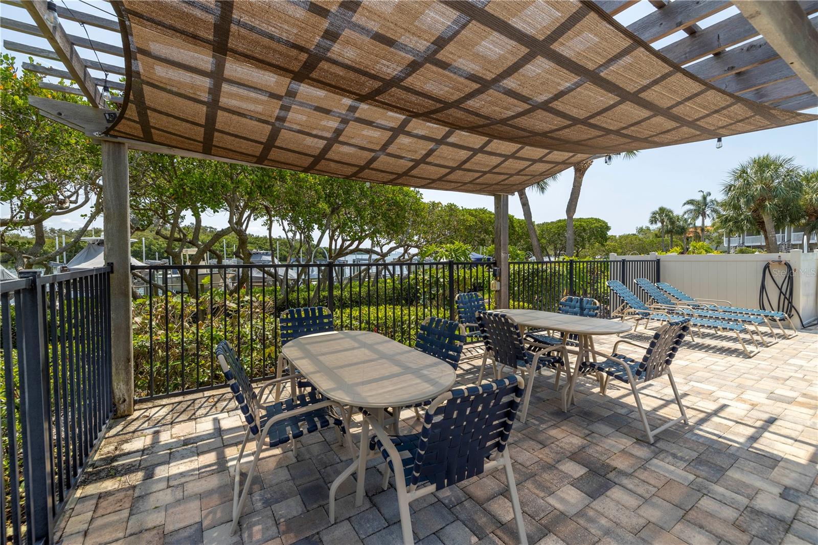 Waterfront community pool with shaded pergola