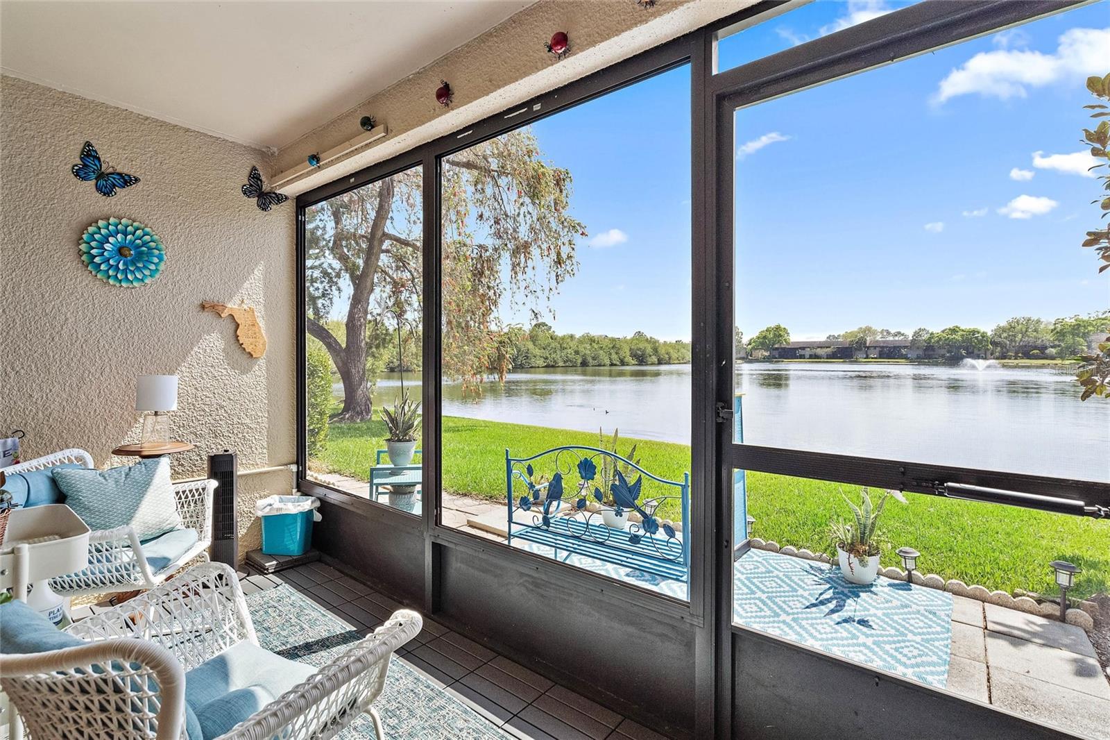 Screened in patio and exterior patio with lake views