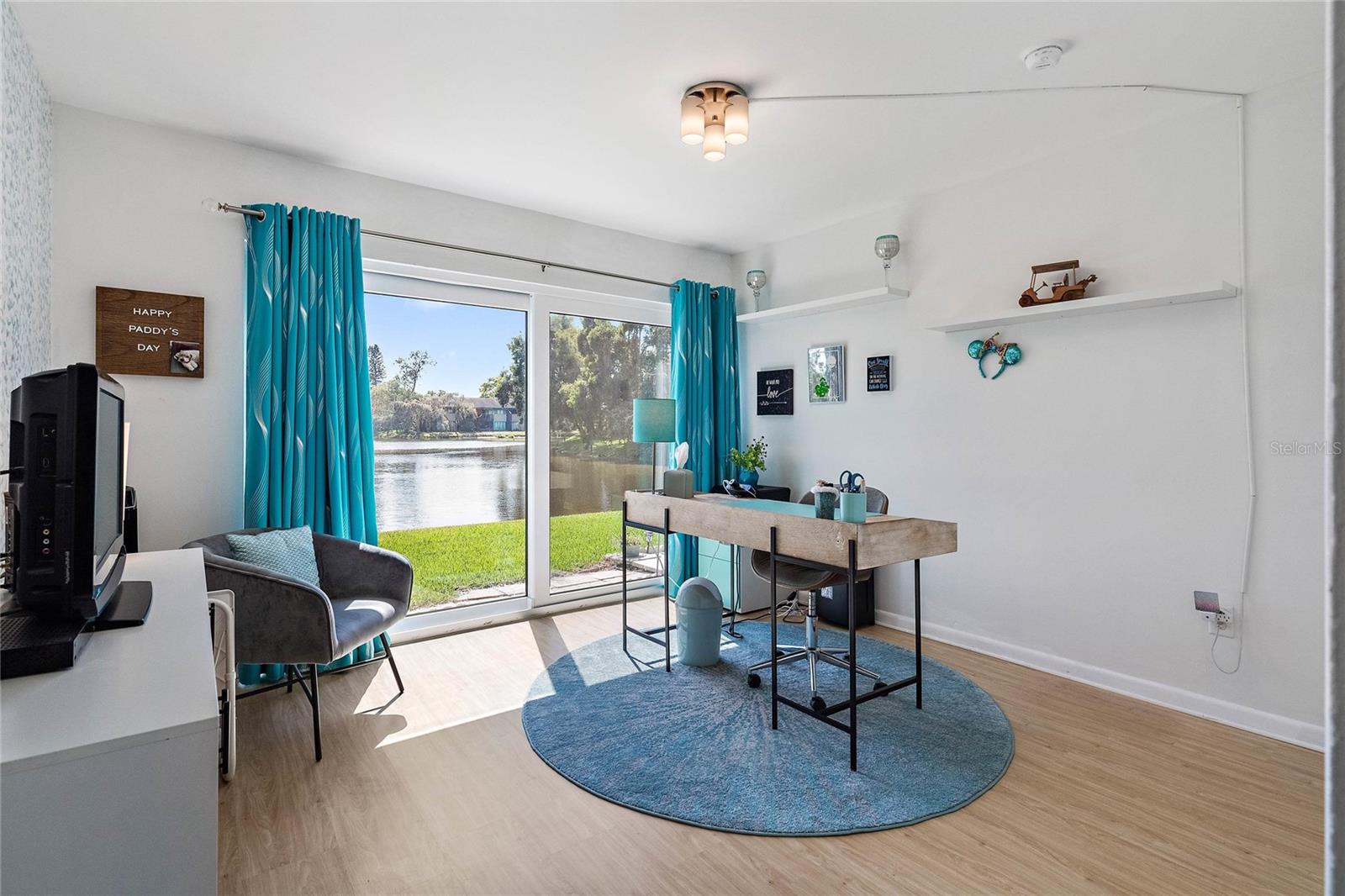 Second Bedroom used here as an office with new Impact sliding door and views of the Lake