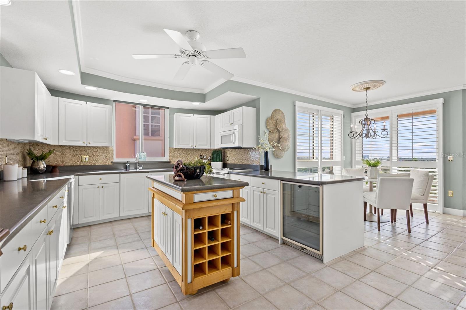 Kitchen is open concept, has ample storage, and a rolling island.