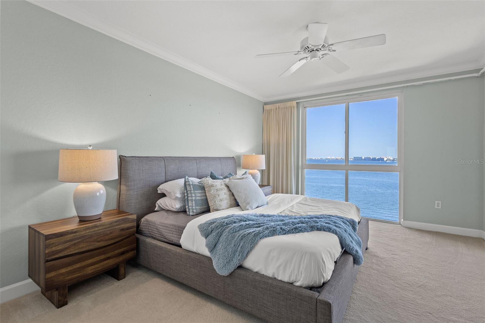 Primary bedroom is large and has a lot of light. You can put down the automatic hurricane shutters to block out all of the light.