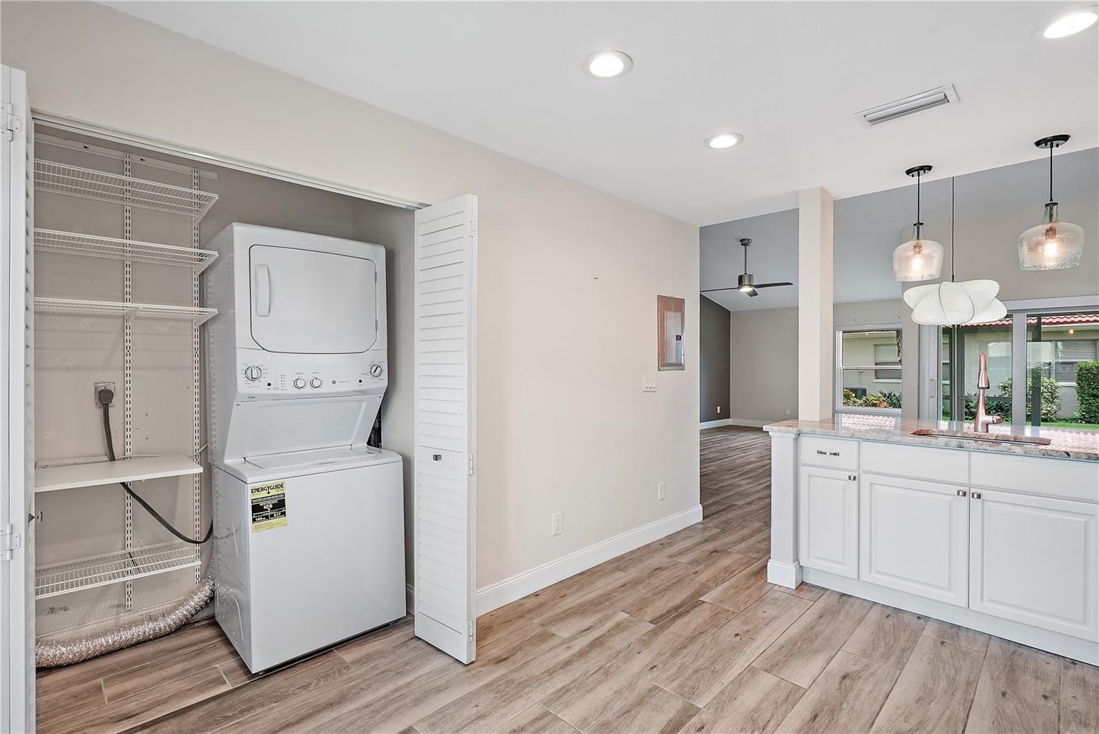 Kitchen area with the built in closet. Washer and dryer convey with the property.  The condo is currently unfurnished; however washer and dryer remain as they are staying with the property.