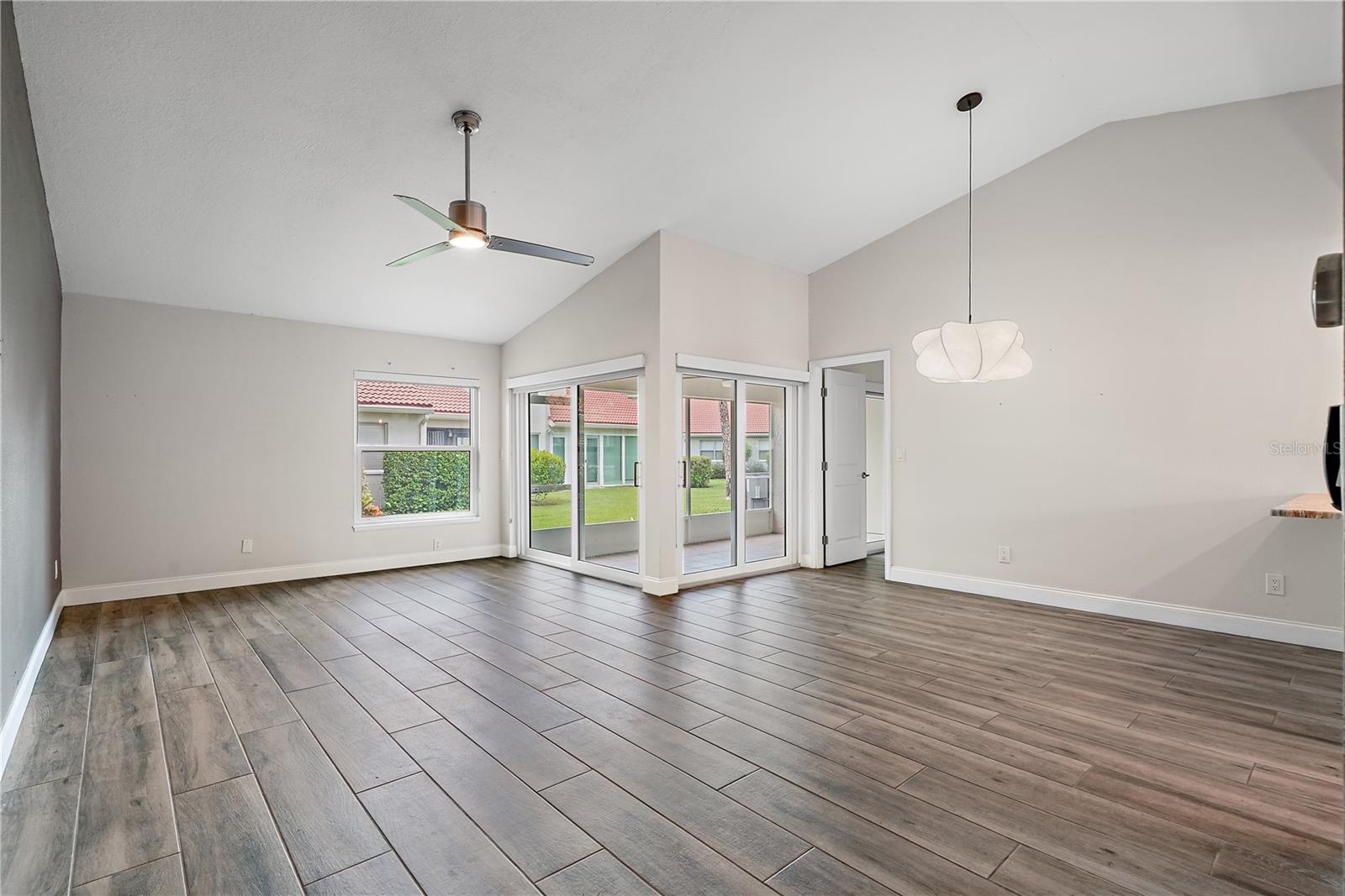 Another view of the main living area with the dining area and patio in view.  The condo is currently unfurnished.