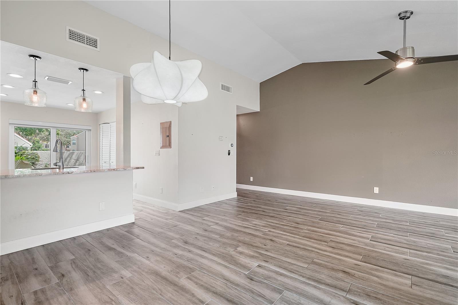 Photo of dining area and part of living room.  The condo is currently unfurnished.