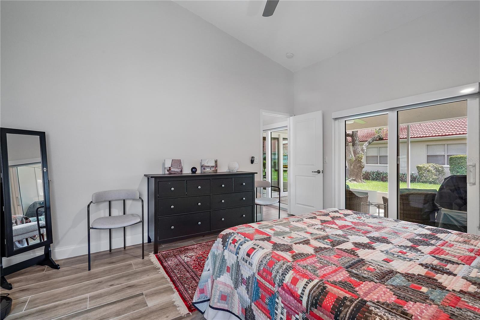 Furnished Master bedroom with a view of the outside patio from the bed angle.  The condo is currently unfurnished.