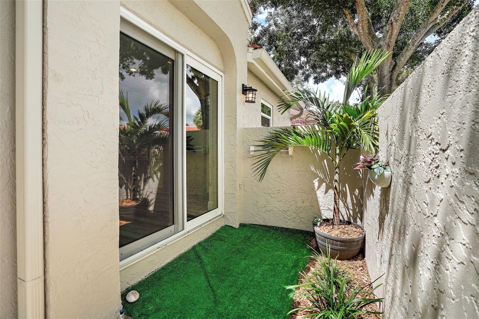 The front patio area.  This is a great area for small gardening, relaxing or perhaps grilling.  The new sliding glass doors lead indoors into the kitchen.