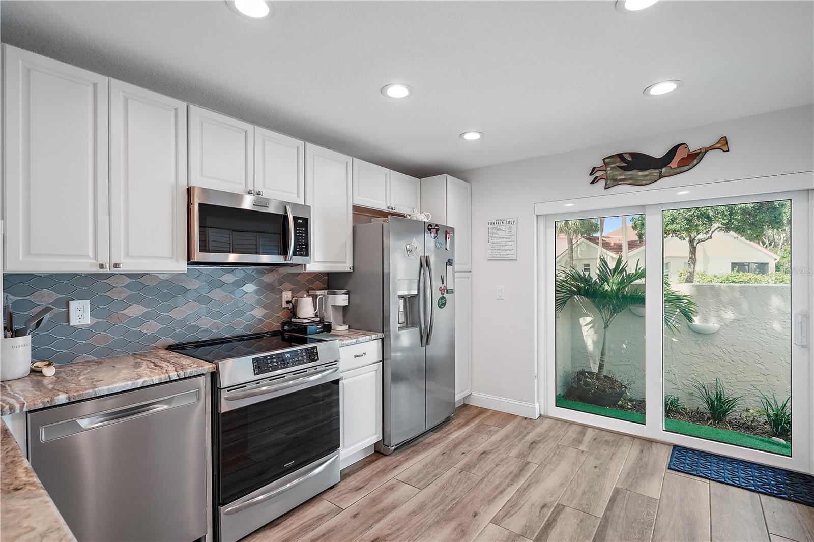 Kitchen furnished.    The sliding glass doors lead onto the front entryway/patio where you can grill if desired.  Please note, the condo is not currently furnished.