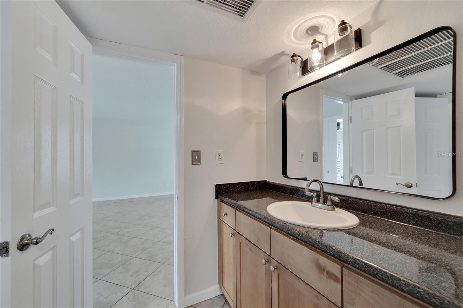 The bathroom with dbl doors from kitchen to bedroom, ideal for guests