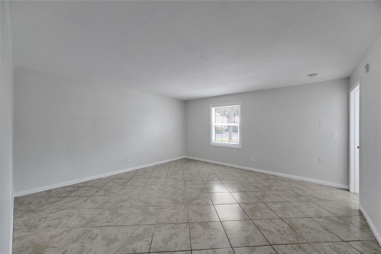 Your huge primary bedroom with windows that look towards Tampa Bay