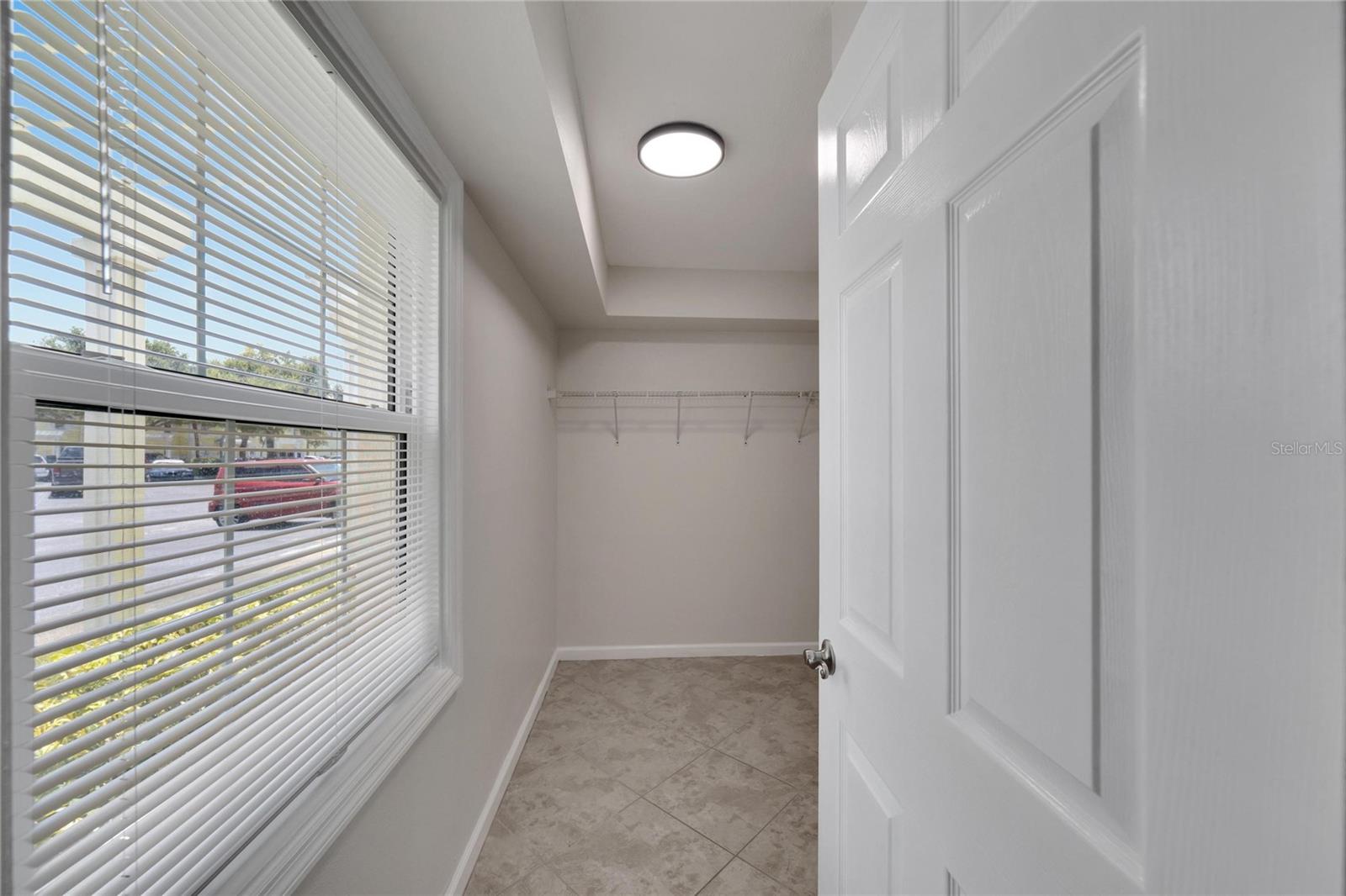 Storage is not an issue with your spacious walk-in closet with window looking towards Tampa Bay