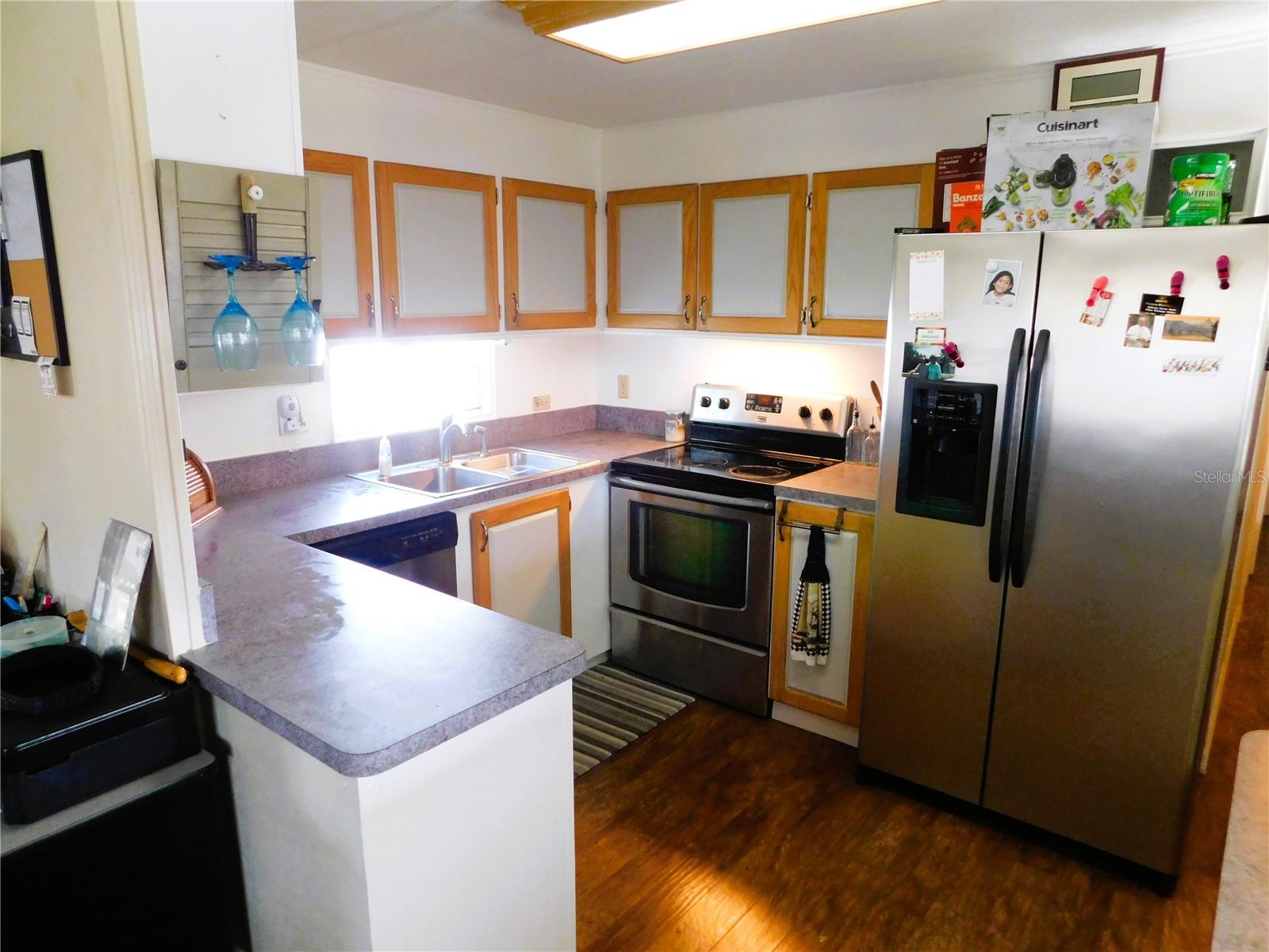 Kitchen offers updated appliances, ample countertops, laminate flooring, and updated fixtures.