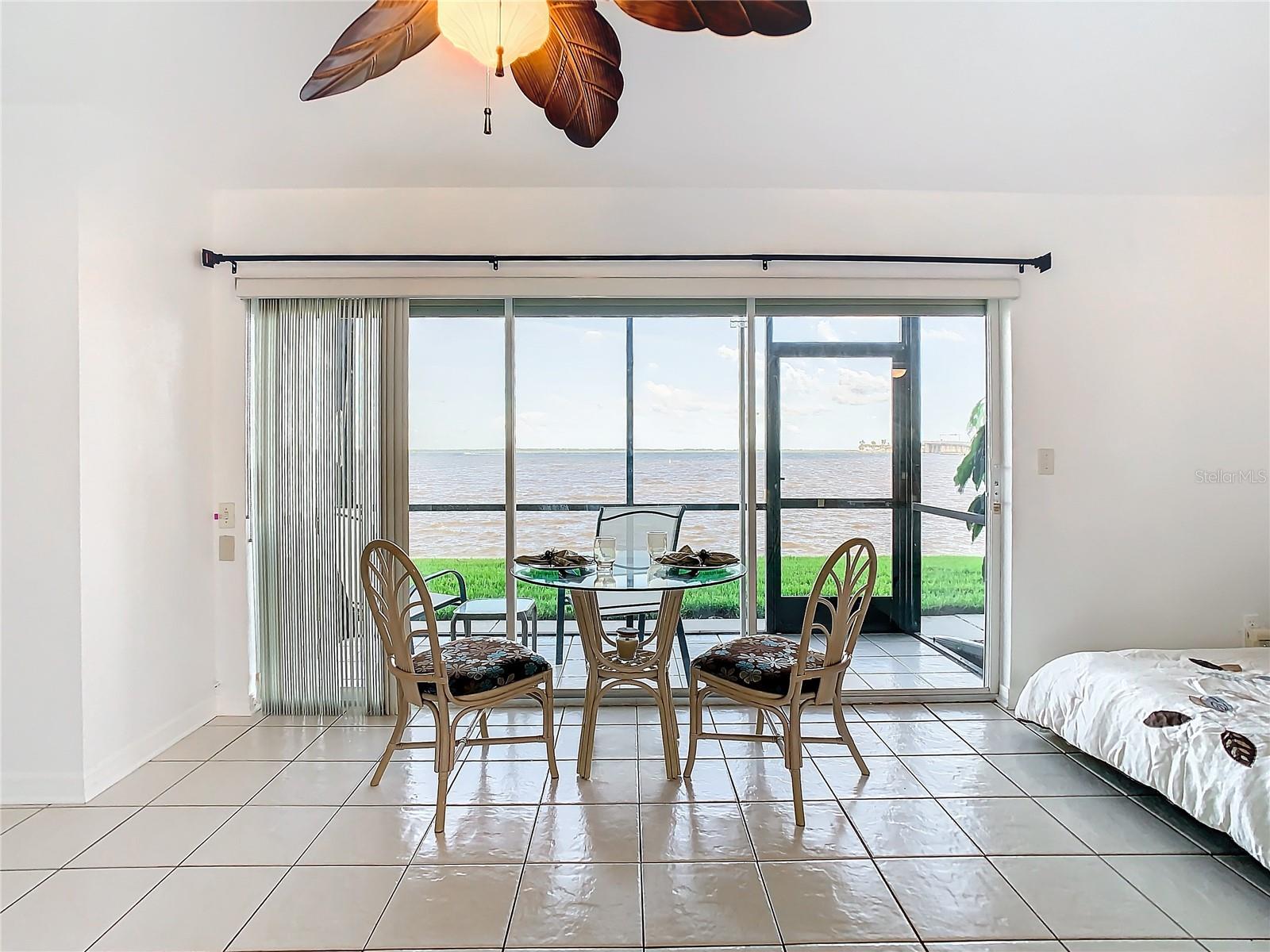 Great room, view towards screen enclosed patio & St. Joseph Sound. Note the cubby with the bed to the right.