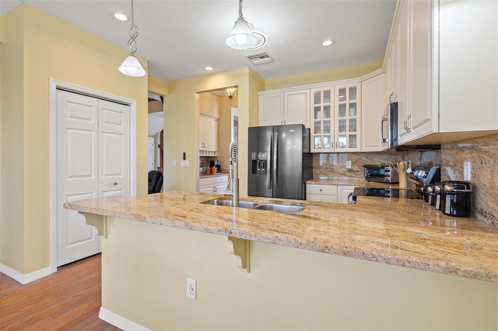 View from dinette area into kitchen and wet bar.