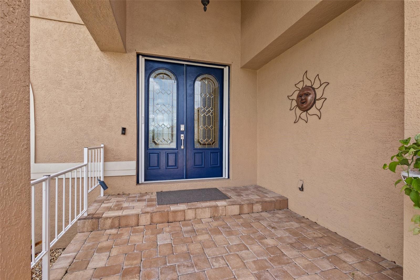 Entry to home with 2 beautiful double doors and beautiful pavers