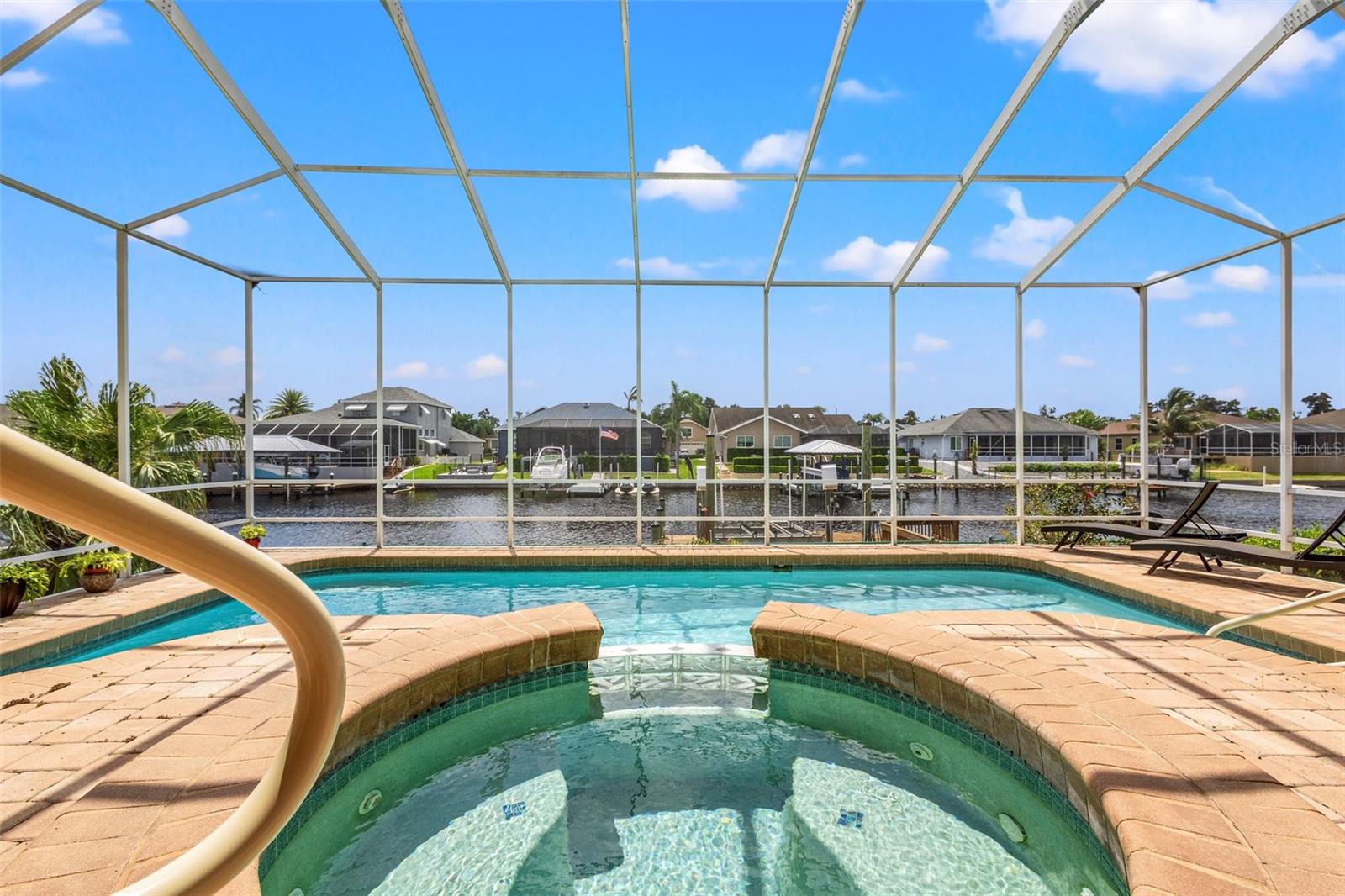 Beautiful pavers line the lanai for gorgeous views of the pebble tech pool and water