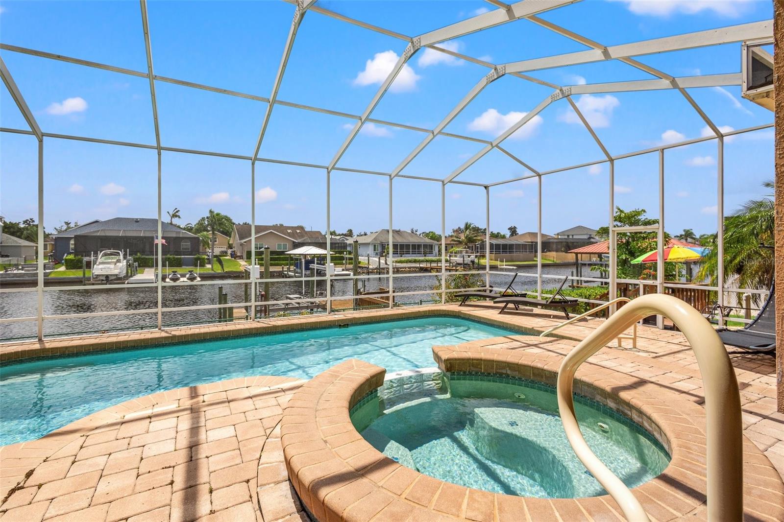 Beautiful pavers line the lanai for gorgeous views of the pebble tech pool and water