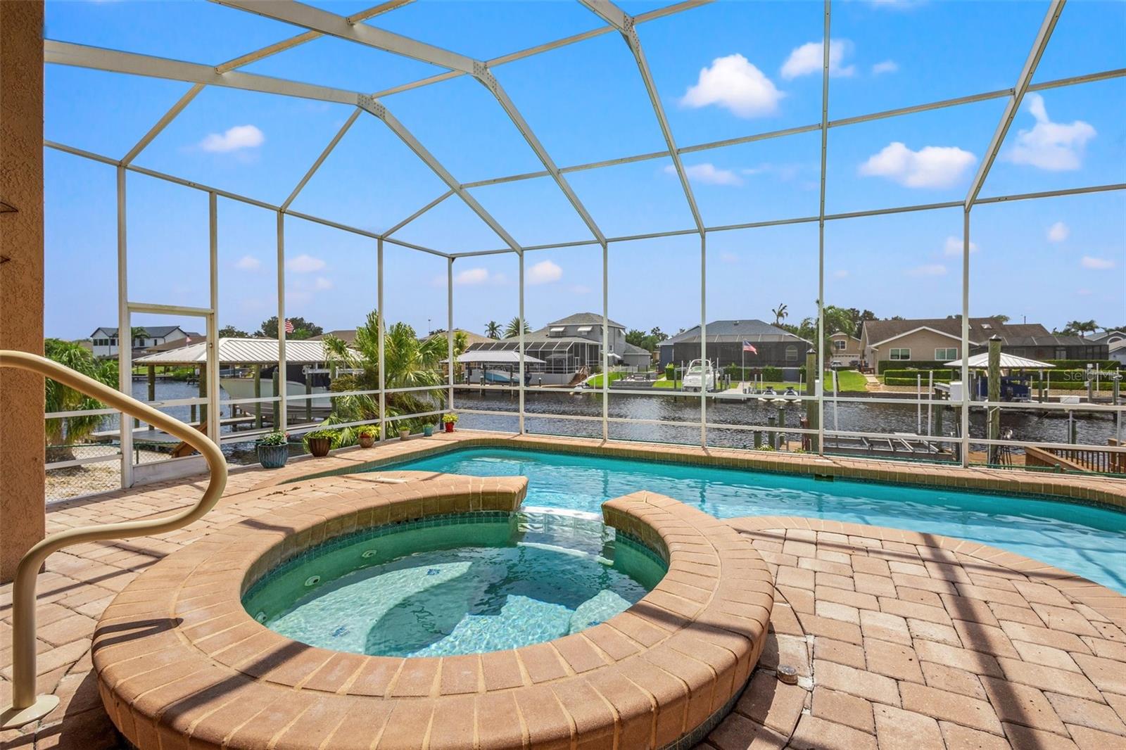 Beautiful pavers line the lanai for gorgeous views of the pebble tech pool and water