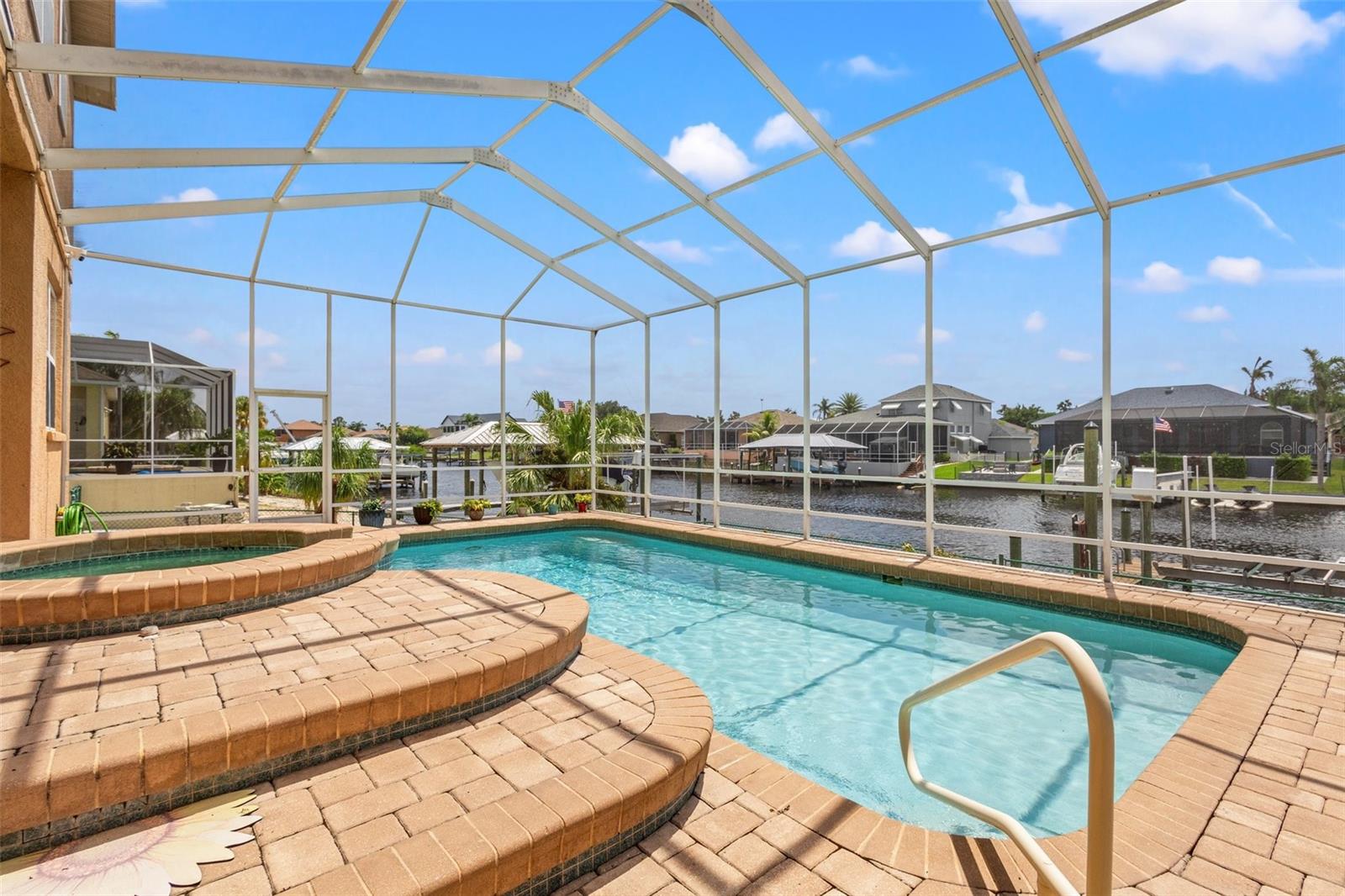 Beautiful pavers line the lanai for gorgeous views of the pebble tech pool and water