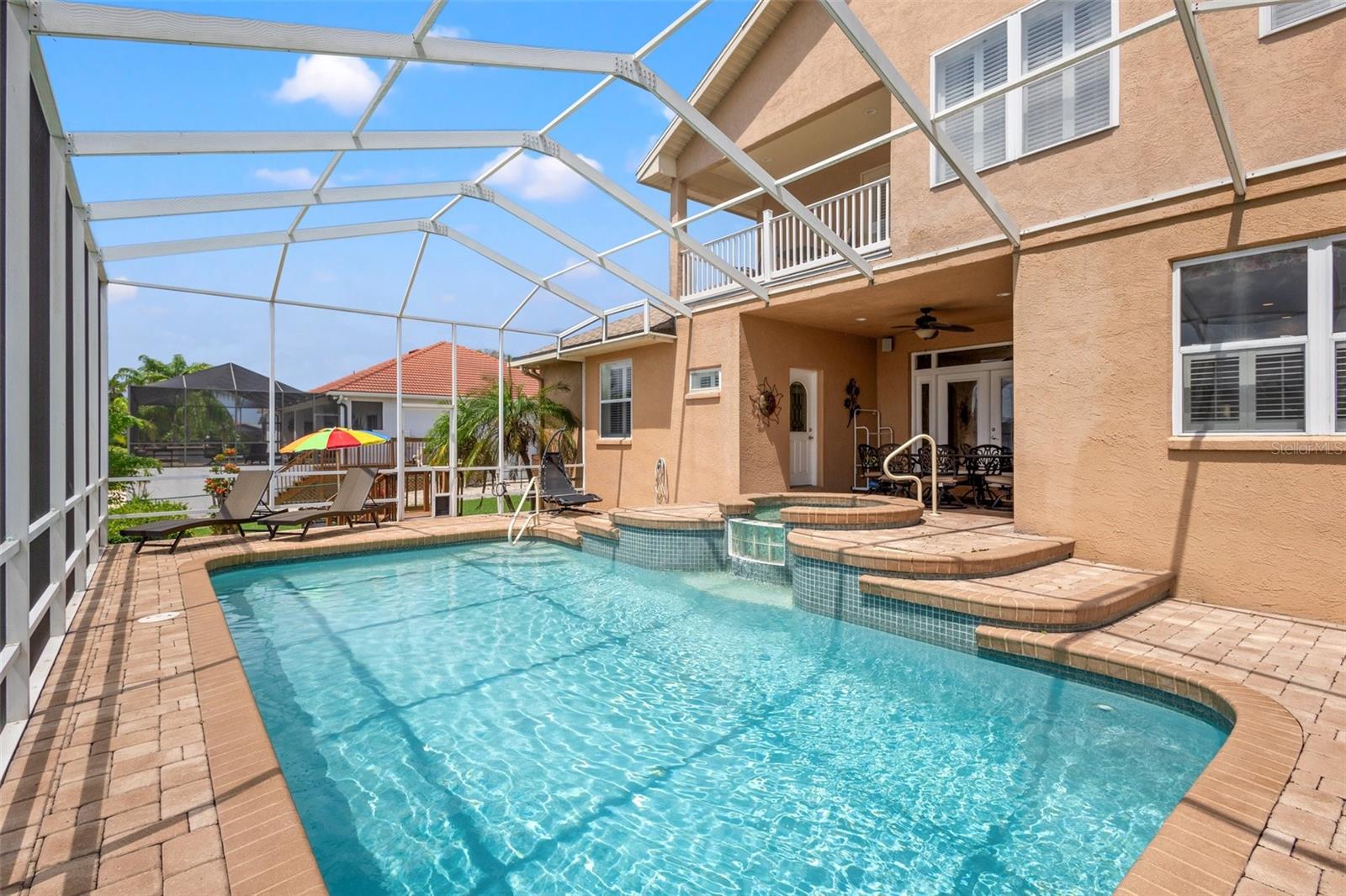 Beautiful pavers line the lanai for gorgeous views of the pebble tech pool and water