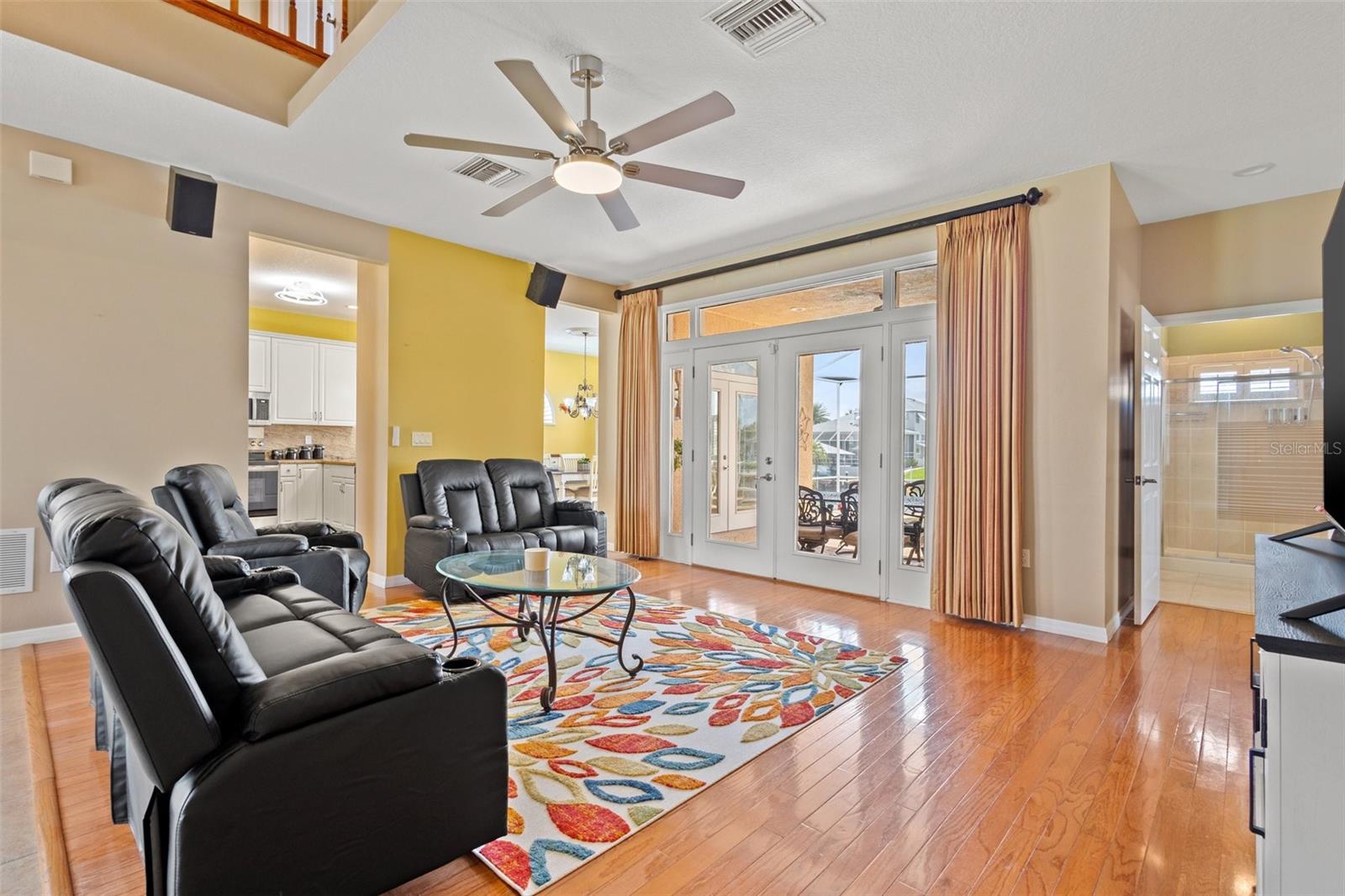 Family Room with view into the kitchen.  Beautiful hardwood floors enhance the natural lighting