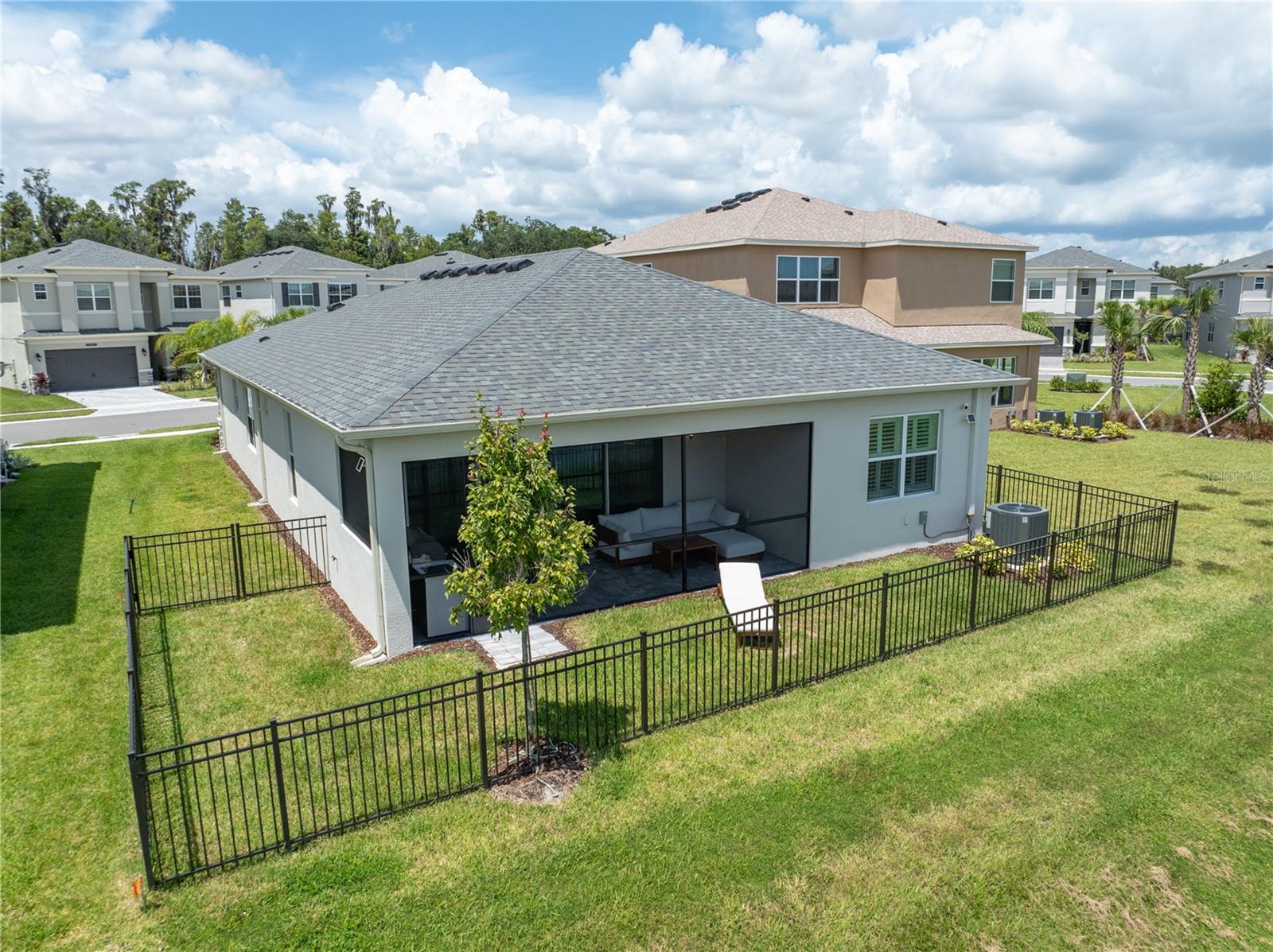 Backyard showing fenced area from pond