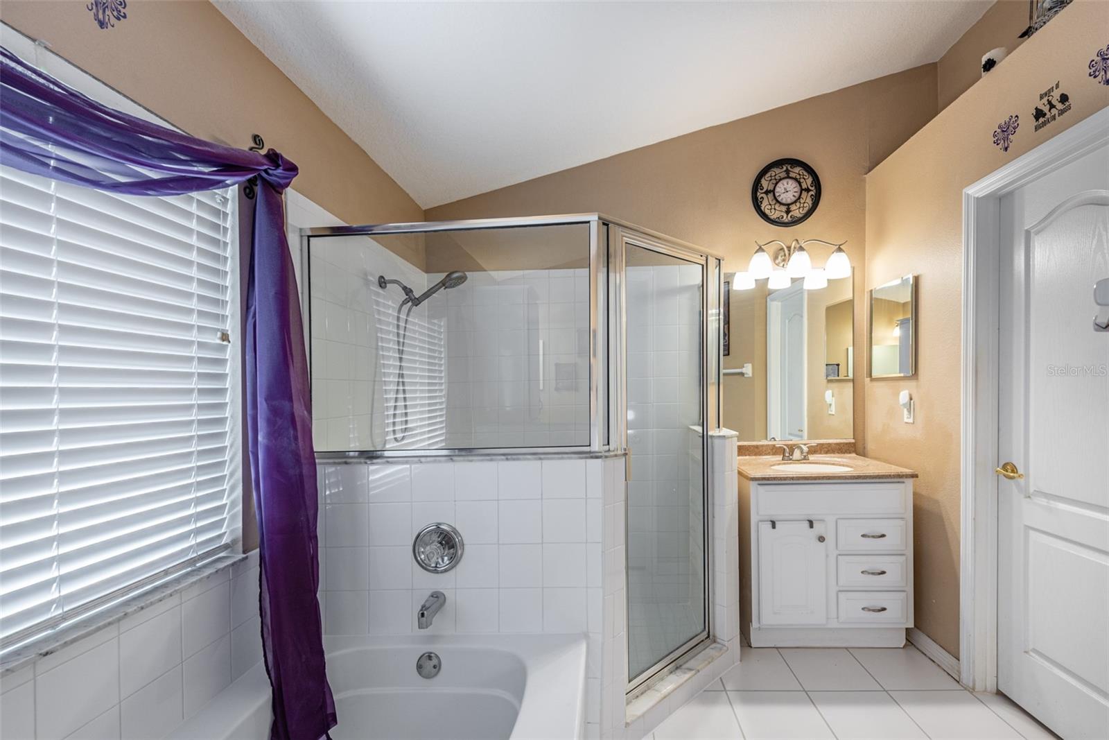 Primary en suite retreat with 2 separate vanities with sinks, a soaking tub, large shower.