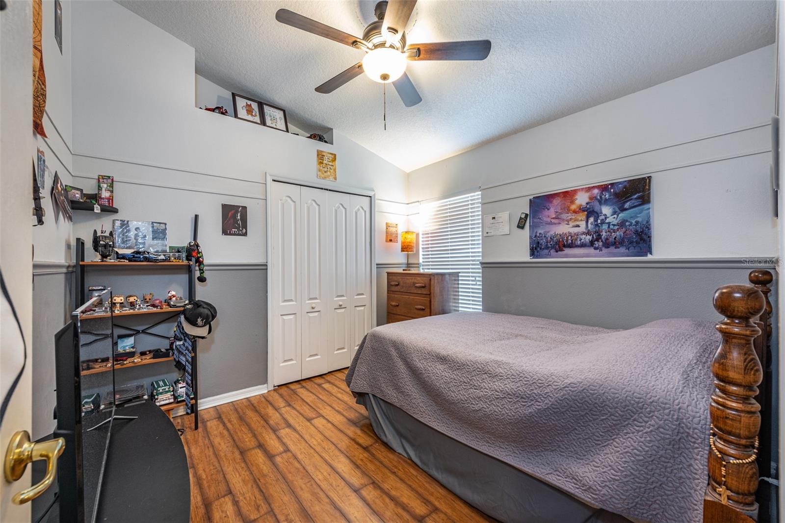 Secondary bedroom #3 is 11' X 11' with laminate flooring and a cathedral ceiling with fan.