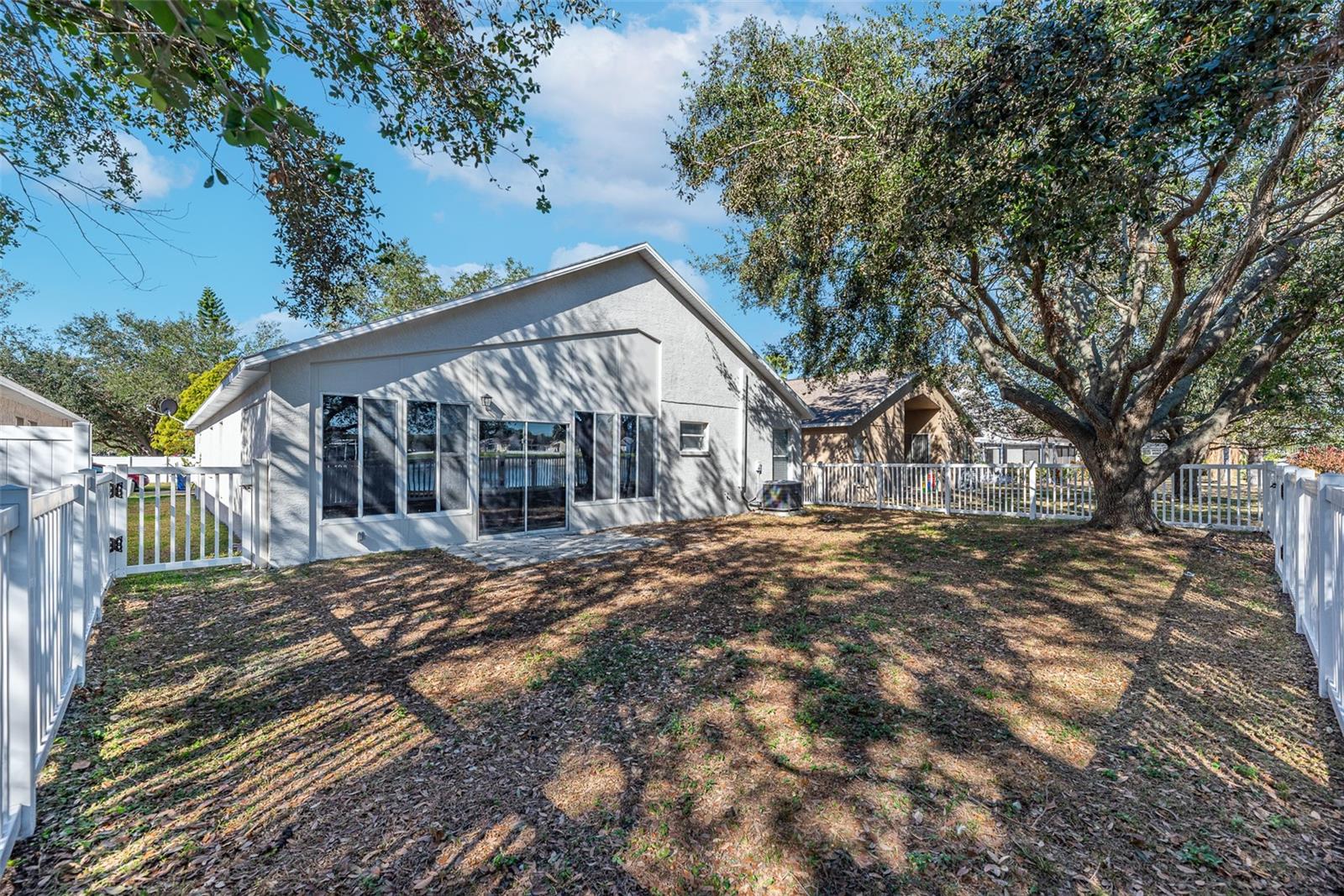 Fully fenced backyard with a gate to the side yard and another gate to the lake.