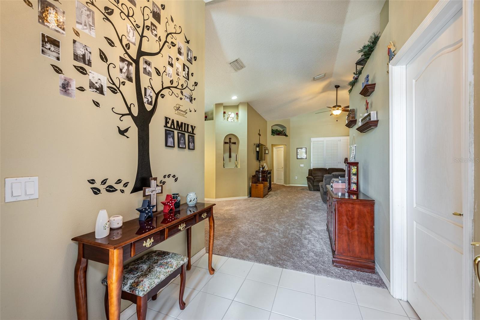 Entering this delightful home you will notice the soaring ceilings starting in the foyer.  Laundry room and access to a two car garage on right.